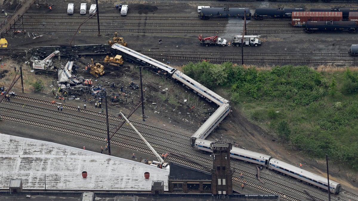  Emergency personnel work at the scene of a deadly train derailment, Wednesday, May 13, 2015, in Philadelphia. The Amtrak train, headed to New York City, derailed and crashed in Philadelphia on Tuesday night, killing at least six people and injuring dozens of others. (AP Photo/Patrick Semansky) 