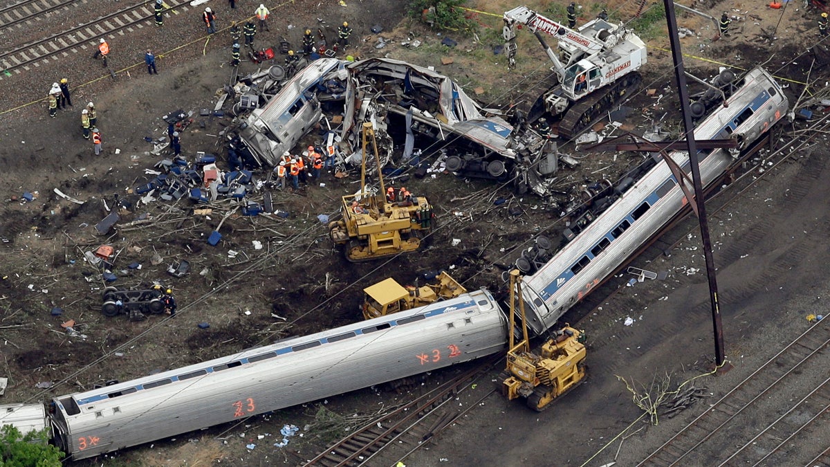 Emergency personnel work at the scene of a deadly train derailment, Wednesday, May 13, 2015, in Philadelphia. The Amtrak train, headed to New York City, derailed and crashed in Philadelphia on Tuesday night, killing at least six people and injuring dozens of others. (Patrick Semansky/AP Photo) 