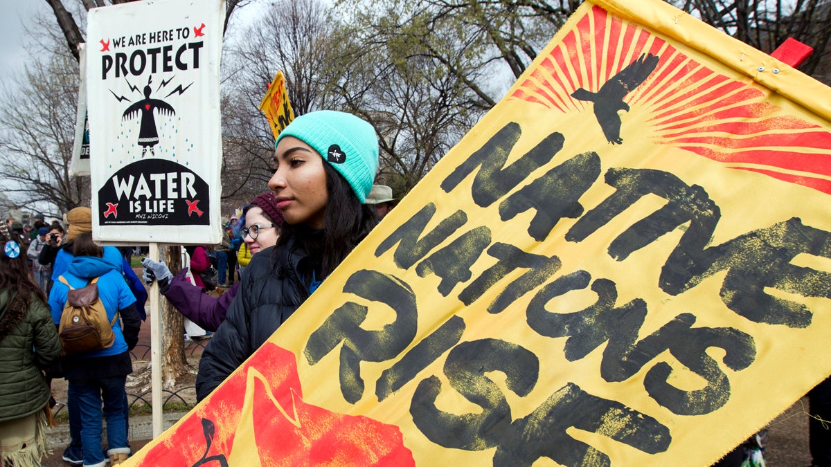  Demonstrators hold their banners during a protest outside of the White House, Friday, March 10, 2017, in Washington, to rally against the construction of the disputed Dakota Access oil pipeline. (Jose Luis Magana/AP Photo) 