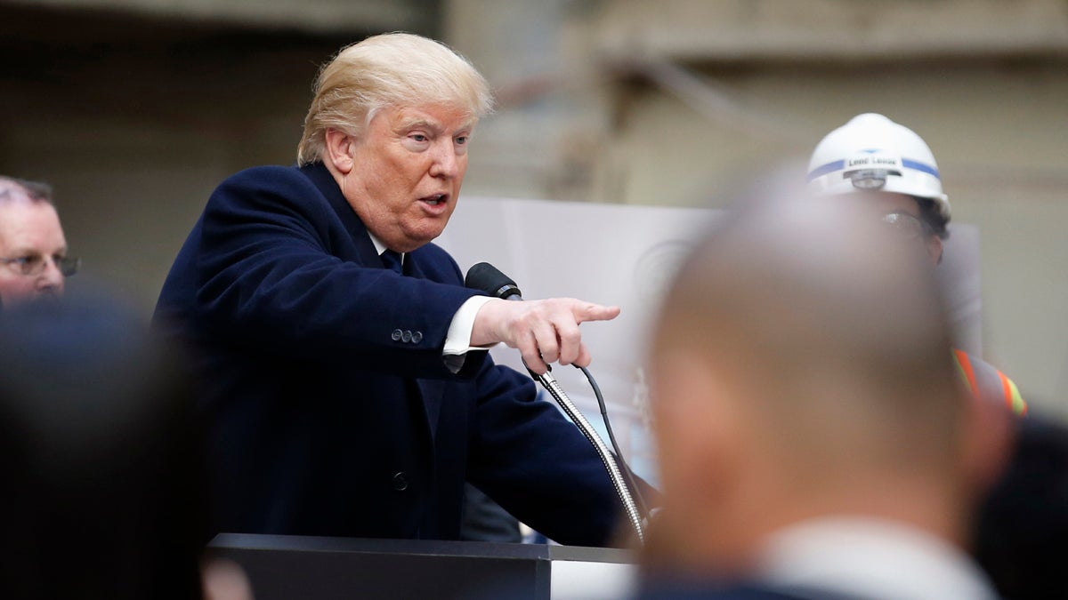 Republican presidential candidate Donald Trump points to a reporter during a campaign event in the atrium of the Old Post Office Pavilion