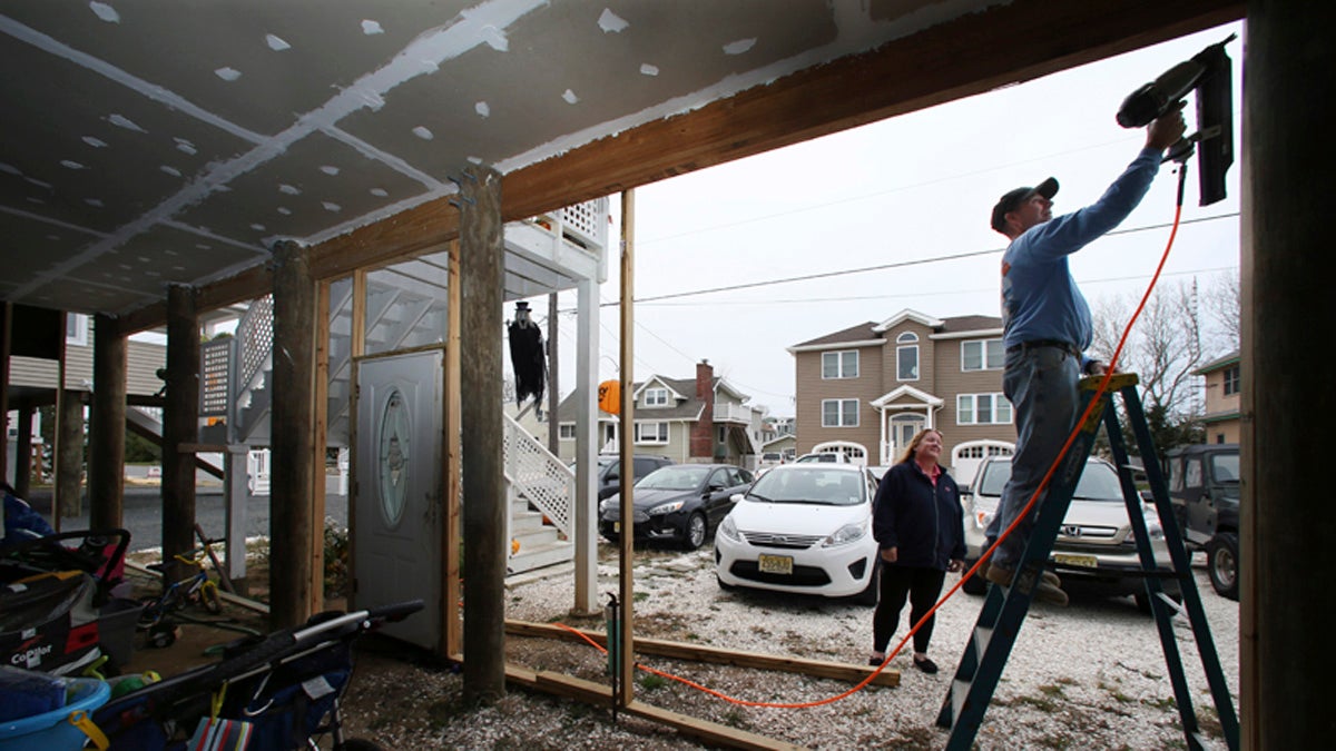  In October 2015,  a couple works on their home that has been raised since being damaged, with about 27 inches of water in their house during Superstorm Sandy, in Long Beach Township, N.J.  (Mel Evans/AP Photo) 
