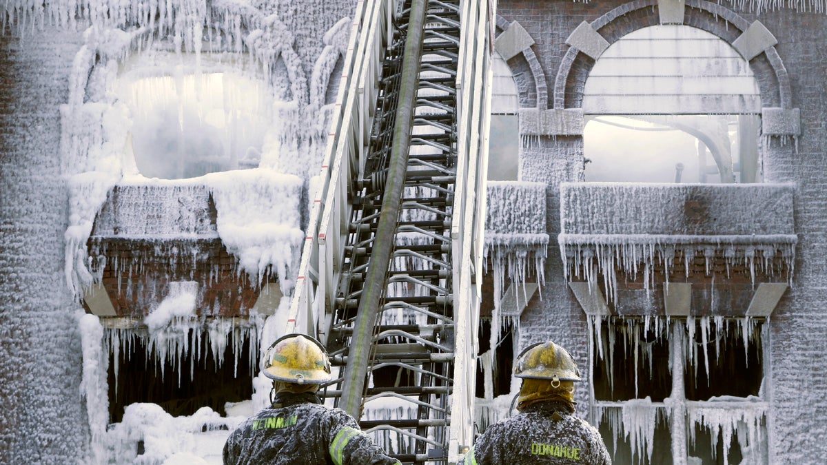  Philadelphia firefighters work the scene of an overnight blaze in West Philadelphia Monday as icicles hang from where the water from their hoses froze. (Jacqueline Larma/AP Photo)  