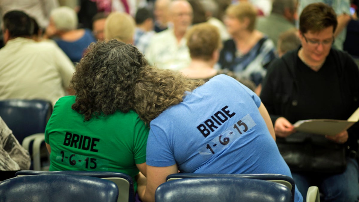  Cristina Jimenez, (left), hugs her future bride, Liz Mabry, as they wait for their marriage license, Monday, Jan. 5, 2015 in Delray Beach, Fla. The couple has been together for 10 years. Florida's ban on same-sex marriage ended statewide at the stroke of midnight Monday, and court clerks in some Florida counties wasted no time, issuing marriage licenses overnight to same-sex couples. (J. Pat Carter/AP Photo) 