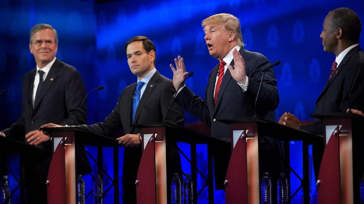  Donald Trump, (second from right), speaks as Jeb Bush, (left), Marco Rubio, (second from left), and Ben Carson look on during the CNBC Republican presidential debate at the University of Colorado in Boulder, Colorado. (Mark J. Terrill/AP Photo)  
