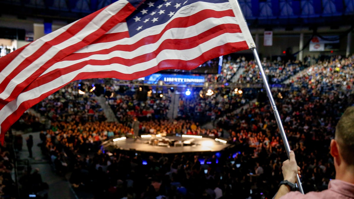  A man in the audience waves an American flag at Liberty University (Andrew Harnik/AP Photo) 