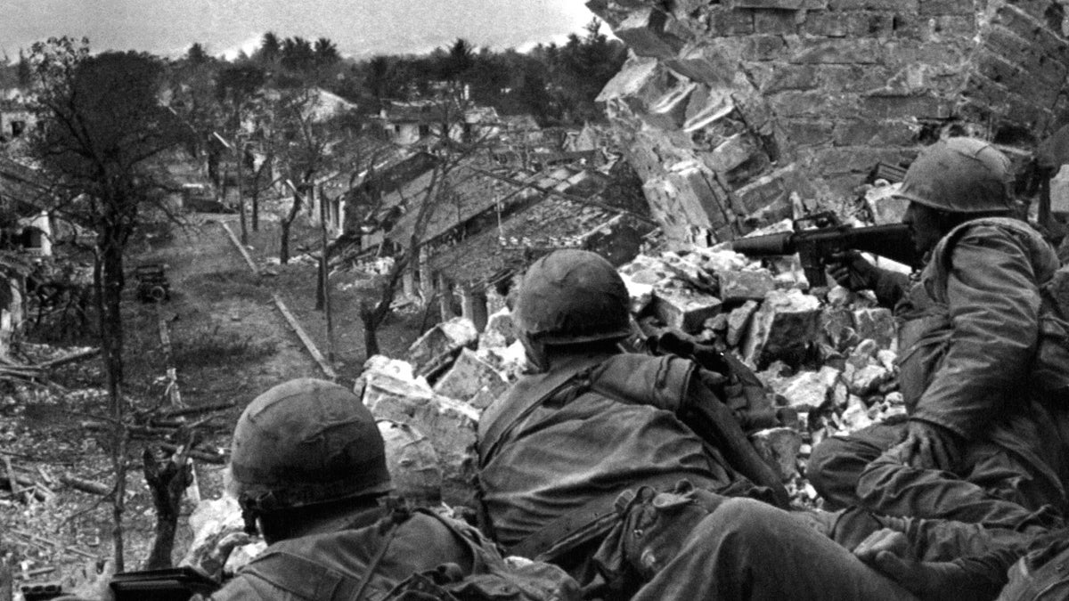  US Marines position themselves atop a tower in Hue’s Citadel, Vietnam, Feb. 20, 1968. (AP Photo) 