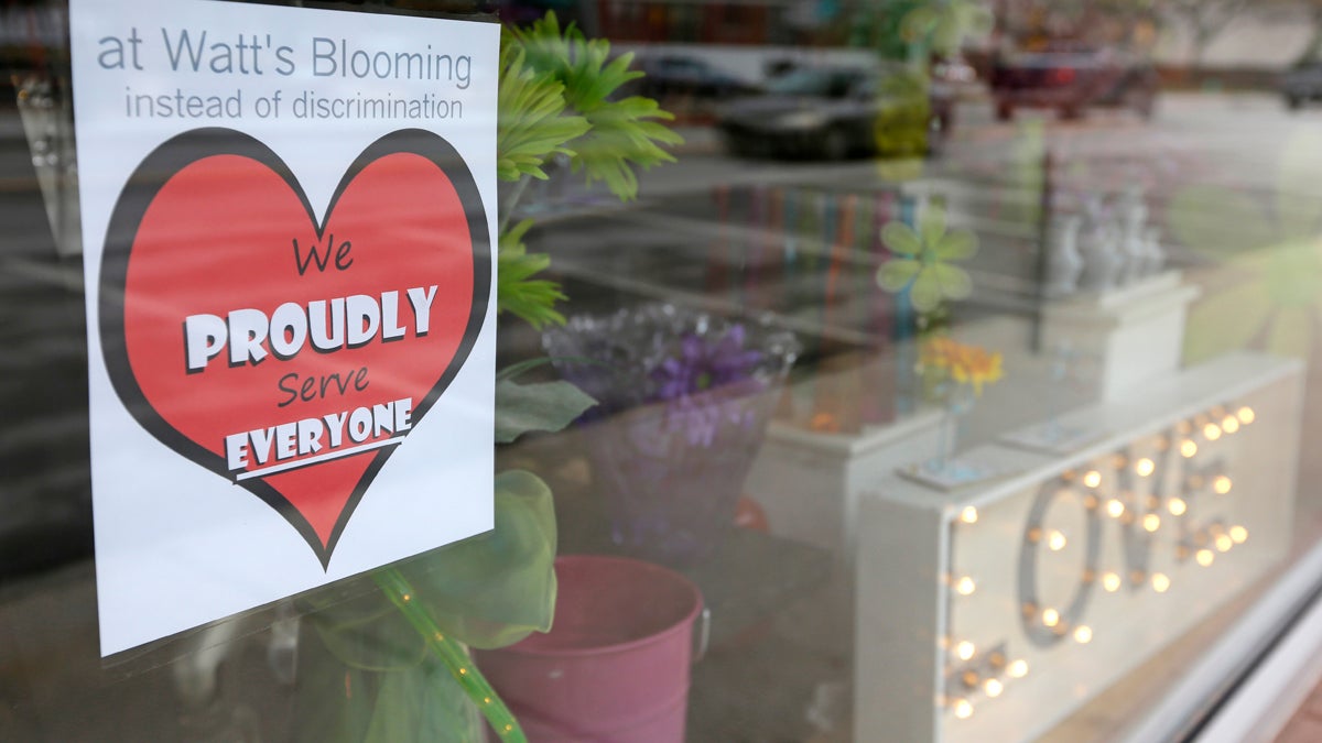  A window sign on a downtown Indianapolis florist, Wednesday, March 25, 2015, shows it's objection to the Religious Freedom bill passed by the Indiana legislature. Organizers of a major gamers' convention and a large church gathering say they're considering moving events from Indianapolis over a bill that critics say could legalize discrimination against gays. (Michael Conroy/AP Photo) 