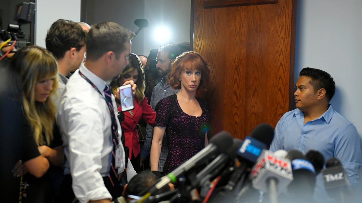  Comedian Kathy Griffin enters a room packed with reporters for a news conference, Friday, June 2, 2017, in Los Angeles to discuss the backlash since Griffin released a photo and video of her displaying a likeness of President Donald Trump's severed head. (Mark J. Terrill/AP Photo) 