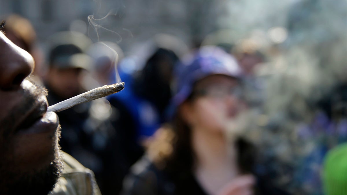  People smoke marijuana cigarettes as a large group gathered near the New Jersey Statehouse to show their support for legalizing marijuana Saturday, March 21, 2015, in Trenton, N.J. (Mel Evans/AP Photo) 