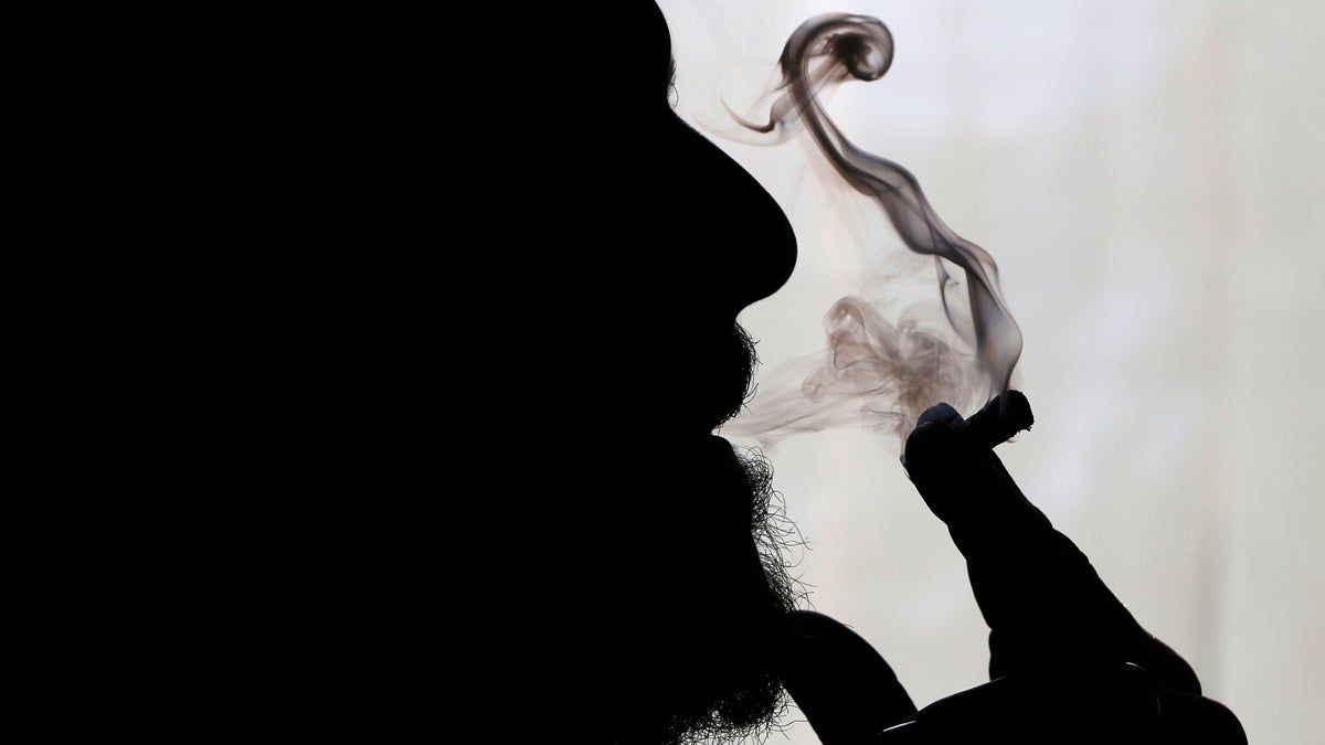  In this Nov. 21, 2014 file photo, former U.S. Marine Sgt. Ryan Begin smokes medical marijuana at his home in Belfast, Maine.  (Robert F. Bukaty/AP Photo, File) 