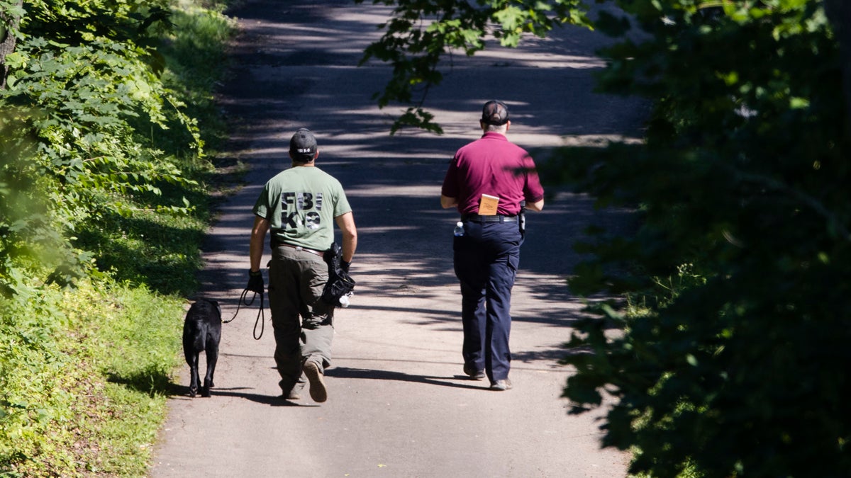 Investigators walk up a blocked off drive way, in, Solebury Township, Pa., on Wednesday, July 12, 2017. (Matt Rourke/AP Photo) 