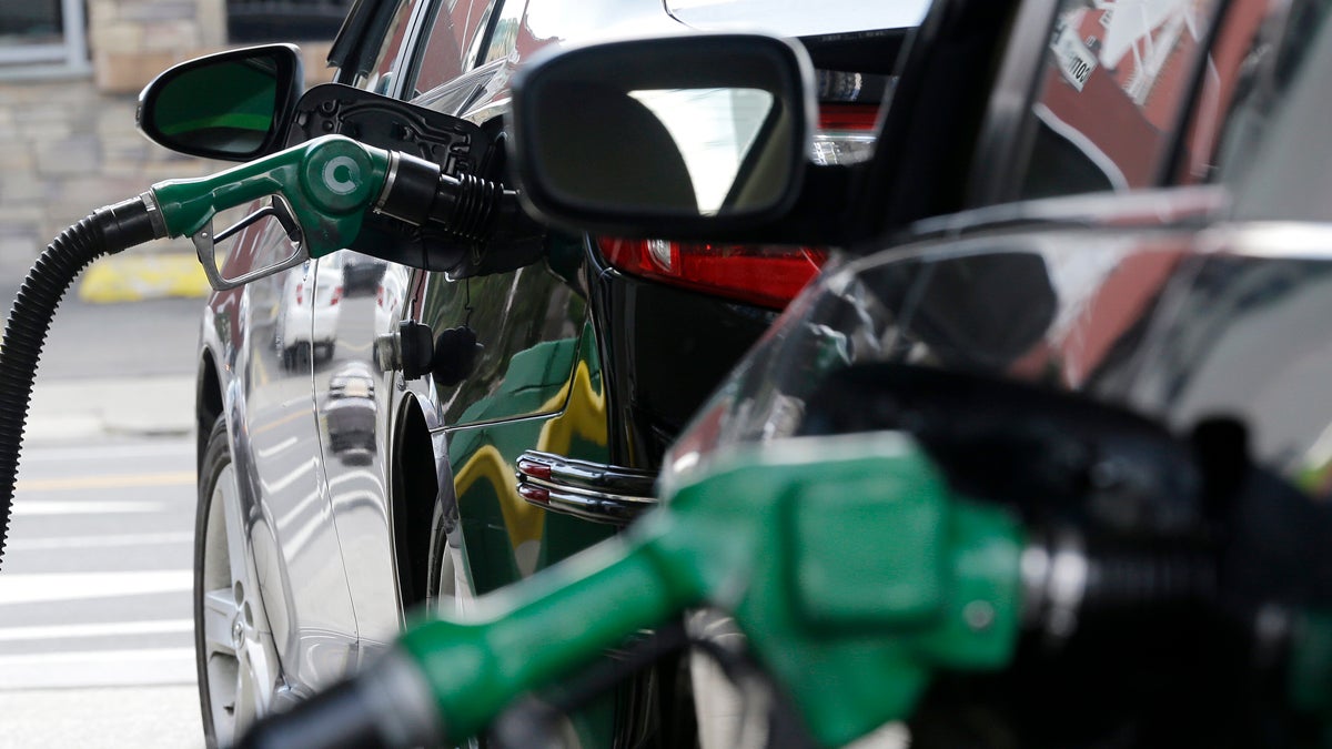 Nozzles pump gas into vehicles at a BP gas station. (Julio Cortez/AP Photo)