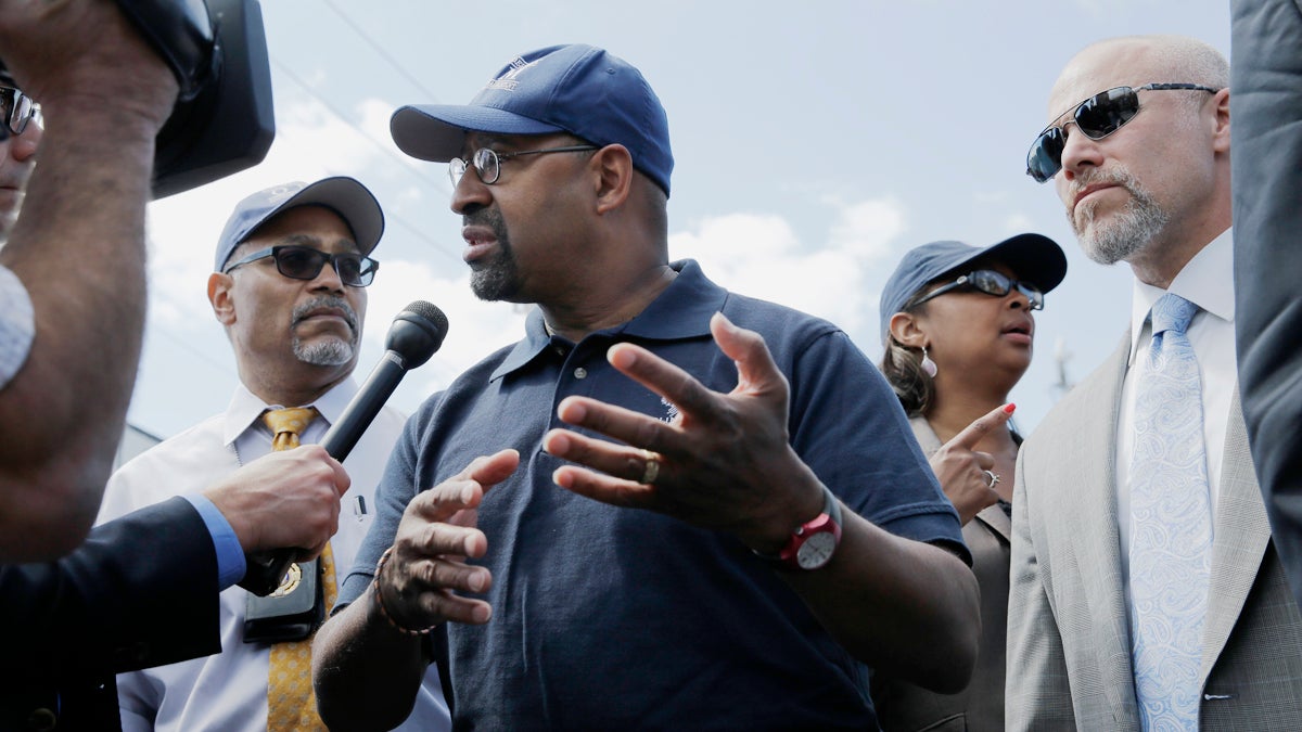  Philadelphia Mayor Michael Nutter (center) answers a question after a news conference near the scene of a deadly train wreck, Wednesday, May 13, 2015, in Philadelphia. (Mel Evans/AP Photo) 