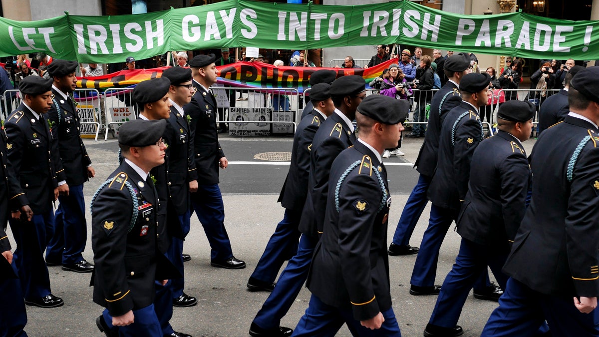 Marchers walk past a group of protesters during the St. Patrick's Day Parade in New York, Tuesday, March 17, 2015. The group was protesting the exclusion of LGBT groups from the parade. (AP Photo/Seth Wenig)