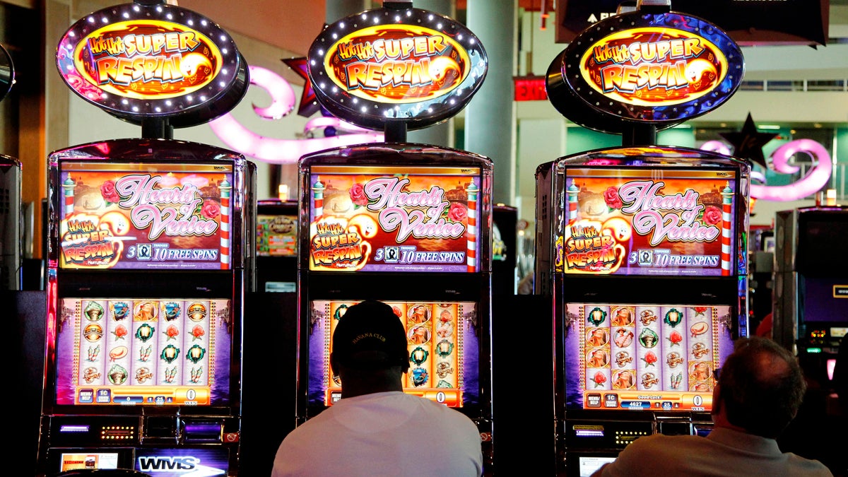  In this May 24, 2012 file photo, patrons play the slot machines at Harrah's Casino in Chester, Pa. (Alex Brandon/AP Photo) 