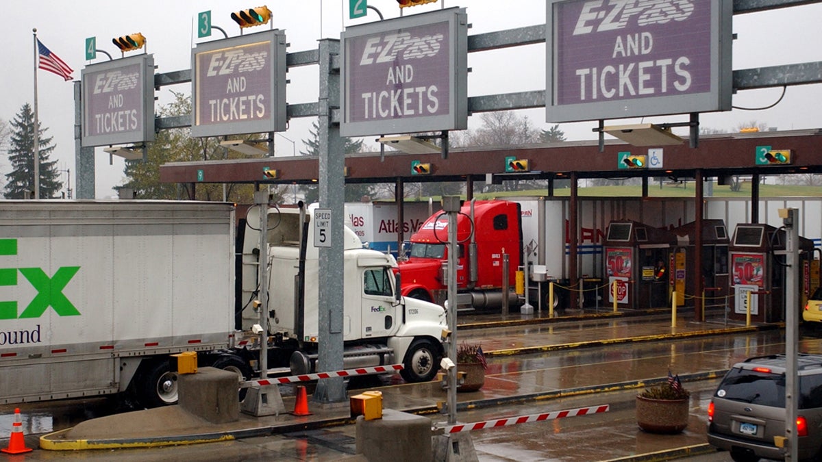 Trucks and cars move through a Pennsylvania Turnpike toll plaza in Carlisle, Pa