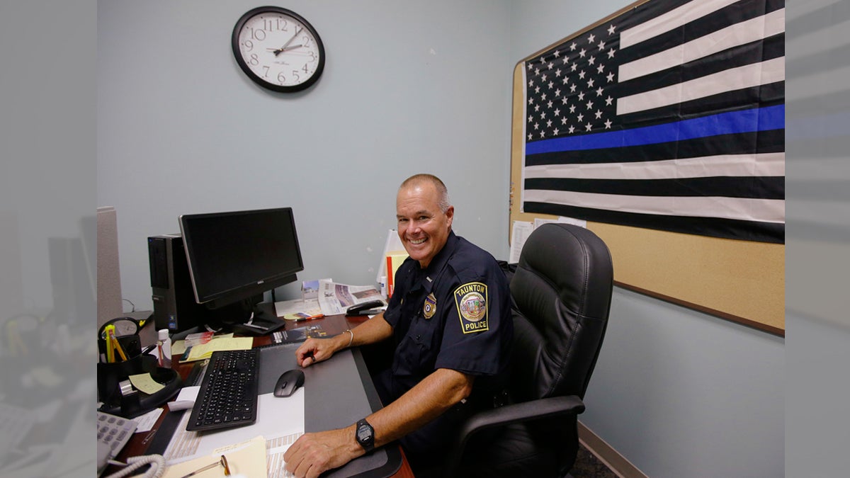  In this Tuesday, July 11, 2017, photo Taunton police Lt. Paul Roderick sits behind his desk at police headquarters in Taunton, Mass. Police departments are increasingly using Facebook to inform the community about what they're doing and who they're arresting. Some add a little humor to the mix. Civil rights advocates complain that posting mugshots and written, pejorative descriptions of suspects amounts to public shaming. Roderick recently wrote and posted an account of the arrest of Amy Rebello-McCarthy. (Stephan Savoia/AP Photo) 