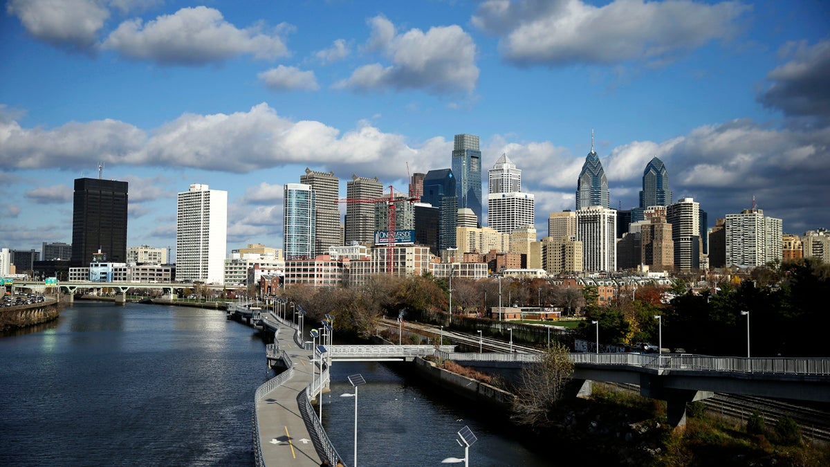 Clouds pass over the Schuylkill River and Philadelphia's skyline. Officials are considering a new plan to preserve or build 100,000 housing units over the next 10 years. (Matt Rourke/AP Photo) 