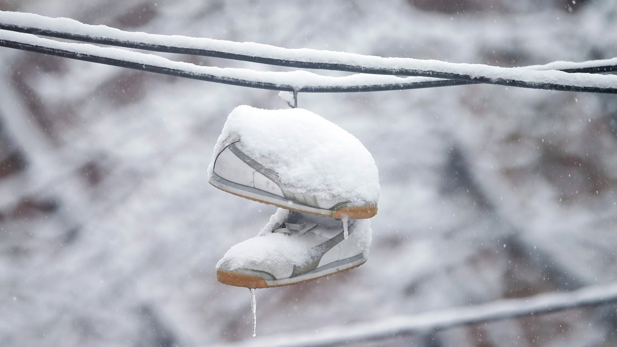  Snow covered shoes dangle from utility lines Thursday, March 5, 2015, during a winter storm in Philadelphia. The Philadelphia area was forecast to receive 5 to 8 inches of snow through Thursday, with lesser amounts to the north and more to the south. (Matt Rourke/AP Photo) 