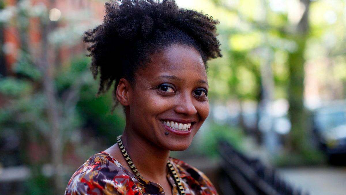  Tracy K. Smith, a creative writing professor at Princeton University, poses in her Brooklyn apartment after winning the Pulitzer Prize for poetry her poetry collection 'Life on Mars,' Monday, April 16, 2012 in New York. (Jason DeCrow/AP Photo) 