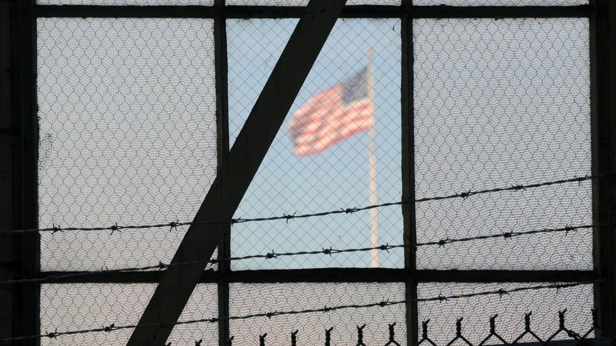  In this photo reviewed by the U.S. Department of Defense, a U.S. flag waves above the the Camp Justice compound at Guantanamo Bay U.S. Naval Base, Cuba, Wednesday, Oct. 17, 2012. (AP Photo/Toronto Star, Michelle Shephard, Pool) 