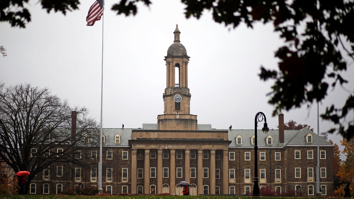  A Penn State student walks in the rain past Old Main on the Penn State main campus in State College, Pa., Wednesday, Oct. 28, 2015. (Gene J. Puskar/AP Photo) 