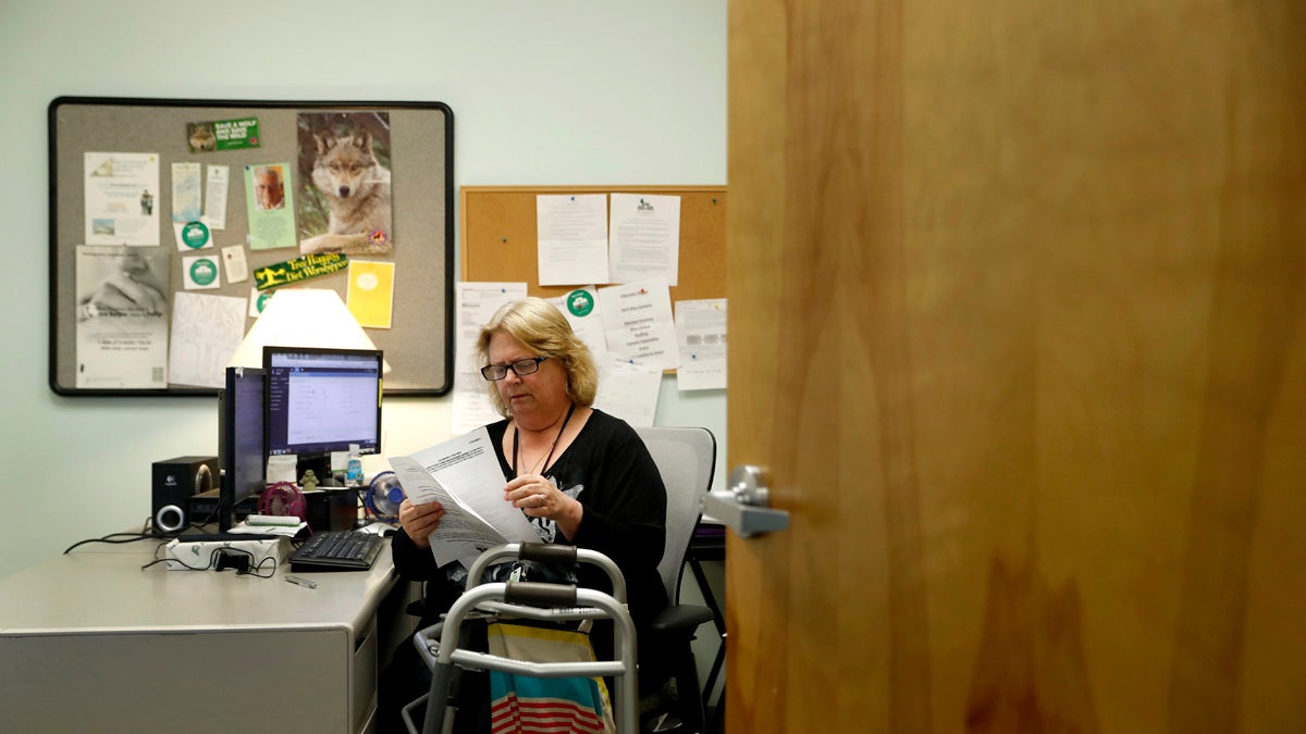  In this Tuesday, March 21, 2017, file photo, Mary Lytle-Gaines works in her office in St. Louis. With her mobile home paid off, the 61-year-old social worker had hoped to semi-retire next year and work part time, but now with insurance premiums likely to rise for her age group and income level she believes that may not be possible. (Jeff Roberson/AP Photo, file) 