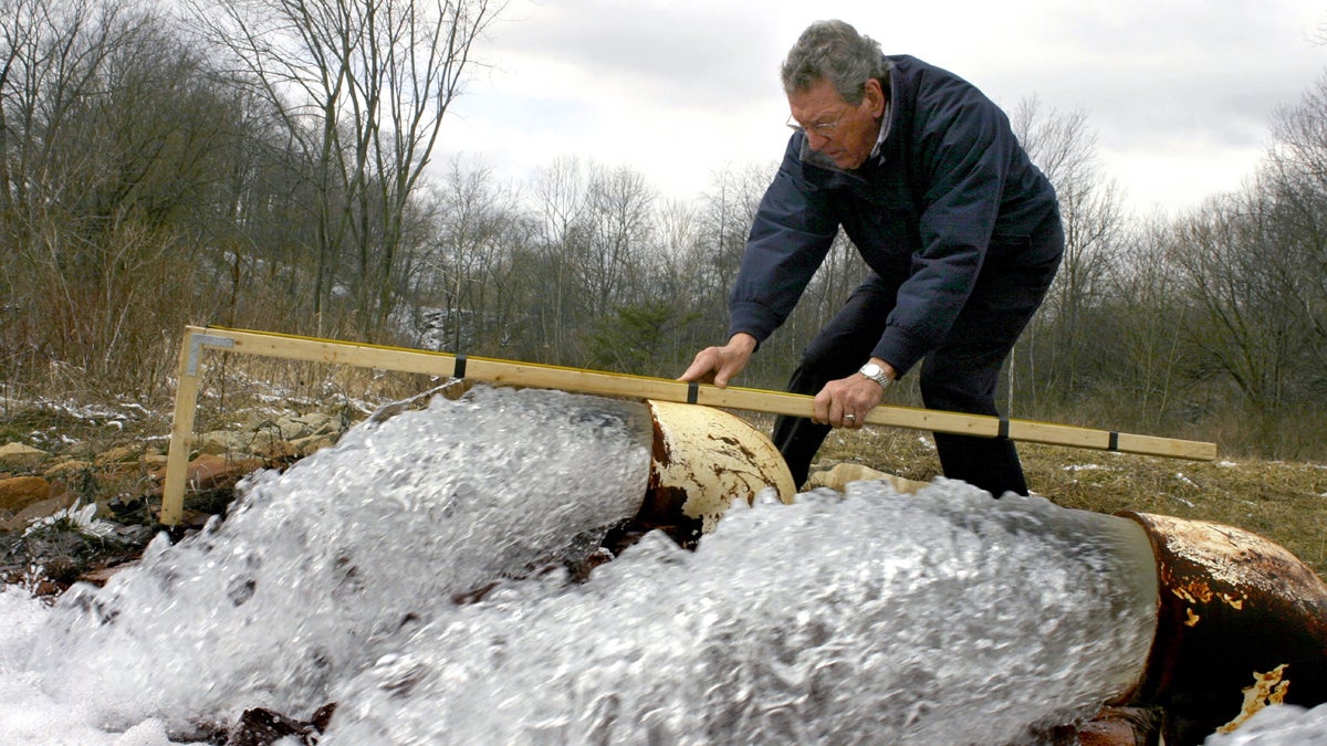 FLOYD EISEMAN In this file photo, Floyd Eiseman, a board member of the Loyalhanna Watershed Association, measures the force of runoff from a flooded underground coal mine in Latrobe, Pa., Friday, March 3, 2006. (Andrew Rush/AP Photo)