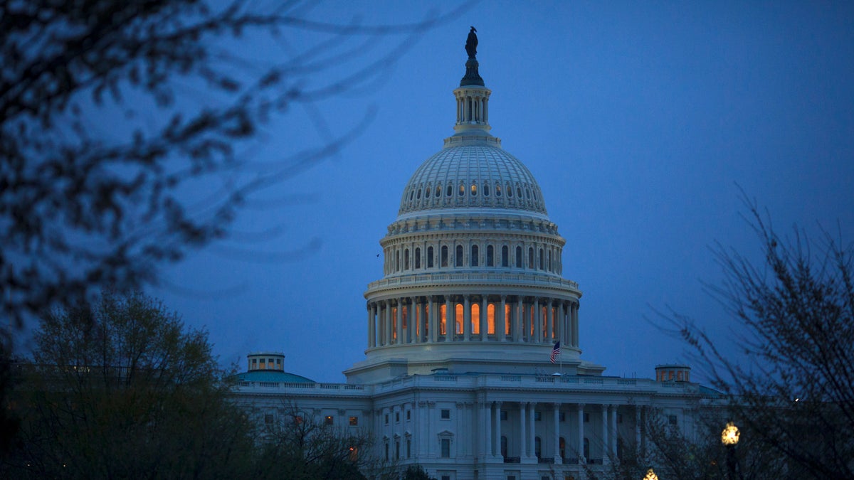 The capitol is seen against a darkened blue sky