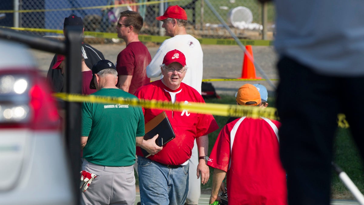  U.S. Rep. Joe Barton, R-Texas, center, and other members of the Republican congressional softball team, stand behind police tape of the scene of a multiple shooting in Alexandria, Va., Wednesday,  where House Majority Whip Steve Scalise of Louisiana was shot. (Cliff Owen/AP Photo) 