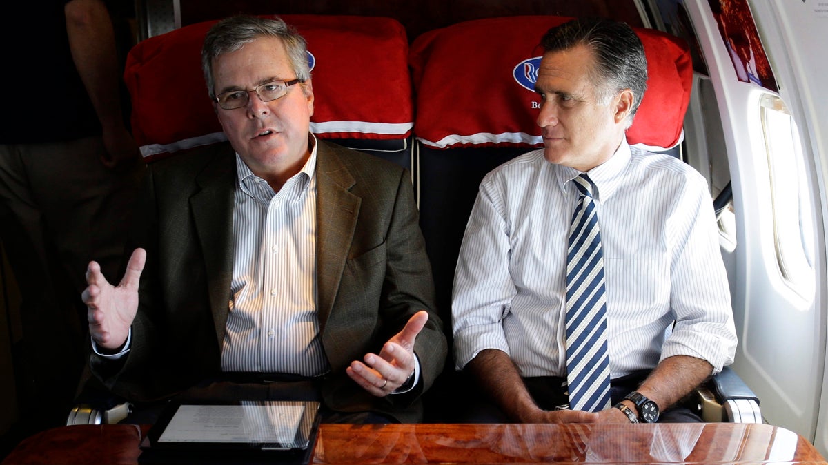  Republican presidential candidate, former Massachusetts Gov. Mitt Romney talks with former Florida Gov. Jeb Bush as they fly on his campaign plane to Miami Fla., Wednesday, Oct. 31, 2012. (AP Photo/Charles Dharapak) 