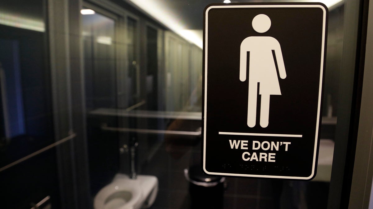  In this photo taken Thursday, May 12, 2016, signage is seen outside a restroom at 21c Museum Hotel in Durham, N.C. North Carolina is in a legal battle over a state law that requires transgender people to use the public restroom matching the sex on their birth certificate. The ADA-compliant bathroom signs were designed by artist Peregrine Honig. (Gerry Broome/AP Photo) 
