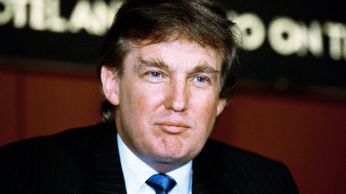 Developer Donald Trump poses for photos outside the New York Stock Exchange after the listing of his stock on Wed.