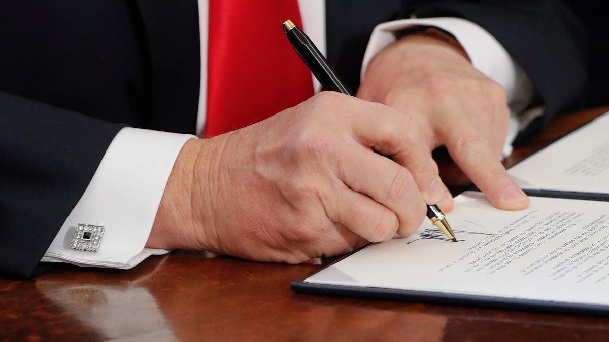  In this Feb. 3, 2017, photo, President Donald Trump signs an executive order in the Oval Office of the White House in Washington. Reality took a beating from the Washington blame game this past week. Americans heard about a Kentucky massacre that never happened, a travel ban that was a ban despite it being called something else, and a dark plot to help Russian intelligence that was nothing of the sort. (AP Photo/Pablo Martinez Monsivais) 
