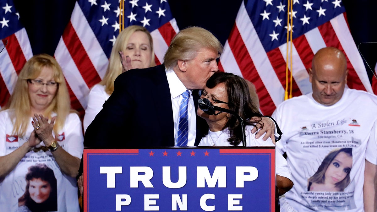 Republican presidential candidate Donald Trump hugs a woman