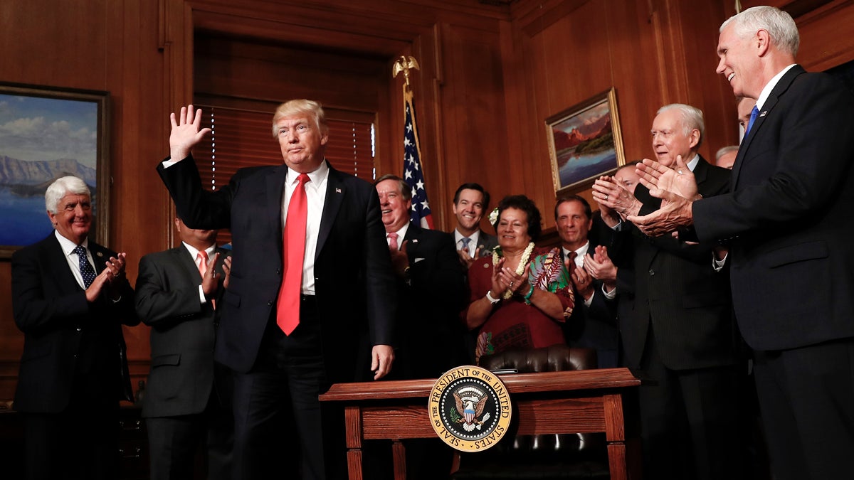  President Donald Trump acknowledge applause after signing an Antiquities Executive Order during a ceremony at the Interior Department in Washington, Wednesday, April, 26, 2017. Th president is asking for a review of the designation of tens of millions of acres of land as 'national monuments.' Front row, from left are, Rep. Ben Bishop, R-Utah, the president and Sen. Orrin Hatch, R-Utah. (Carolyn Kaster/AP Photo) 