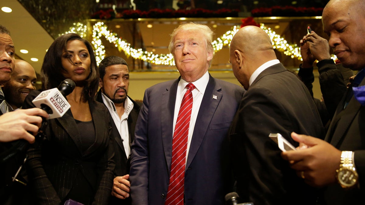  Republican Presidential candidate Donald Trump (center), joins a group of African-American religious leaders to speak to reporters in New York, Monday, Nov. 30, 2015. Trump met with a coalition of 100 African-American evangelical pastors and religious leaders in a private meeting at Trump Tower. (Seth Wenig/AP Photo) 