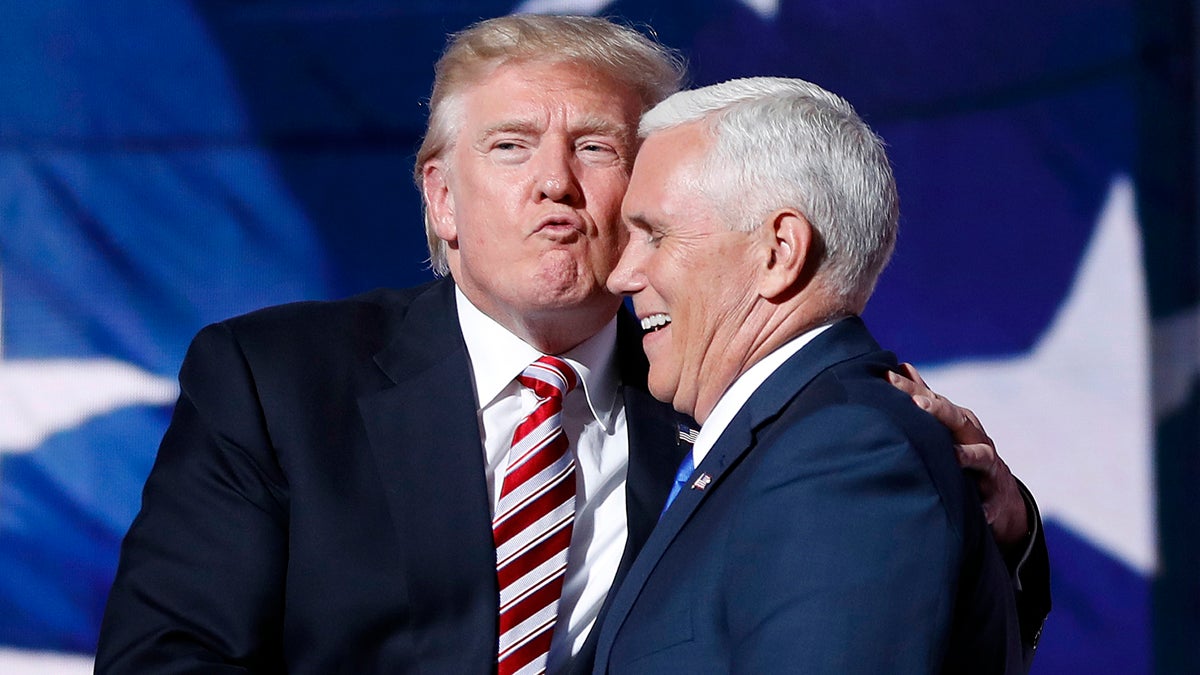  Republican presidential Candidate Donald Trump gives his running mate, Republican vice presidential nominee Gov. Mike Pence of Indiana a kiss as they shake hands after Pence's acceptance speech during the third day session of the Republican National Convention in Cleveland, Wednesday, July 20, 2016. (Mary Altaffer/AP Photo) 