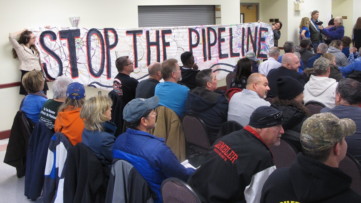 Pinelands Pipeline Opponents of a natural gas pipeline proposed to run through the federally protected Pinelands in New Jersey unfurl a banner against it during a public hearing on the proposal in Pemberton, N.J. on Tuesday Jan. 24, 2017. Environmentalists fear the pipeline will damage the fragile forest, but business and labor groups say it will create jobs and increase energy reliability. (Wayne Parry/AP Photo)
