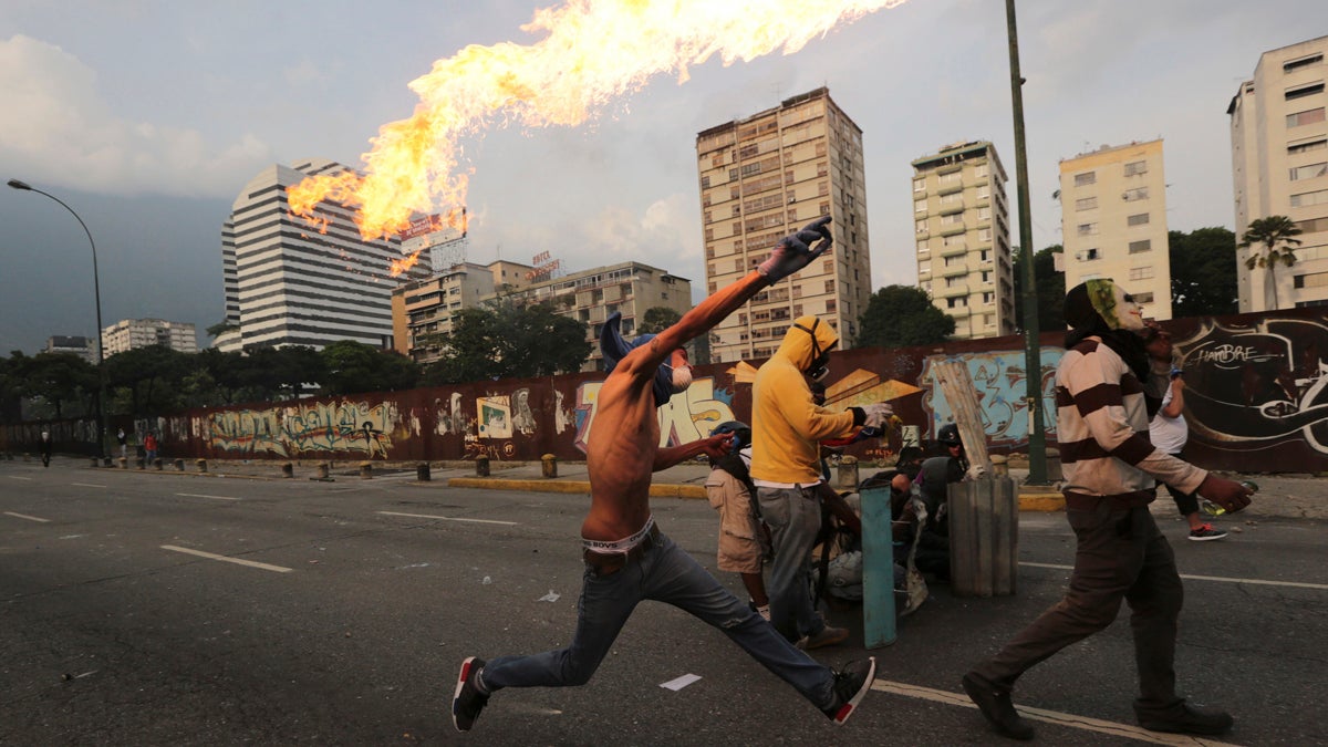  In this April 19, 2017 photo, an anti-government protesters throws a molotov bomb at security forces in Caracas, Venezuela. Tens of thousands of opponents of President Nicolas Maduro flooded the streets of Caracas in what's been dubbed the 'mother of all marches' against the embattled socialist president. (Fernando Llano/AP Photo) 