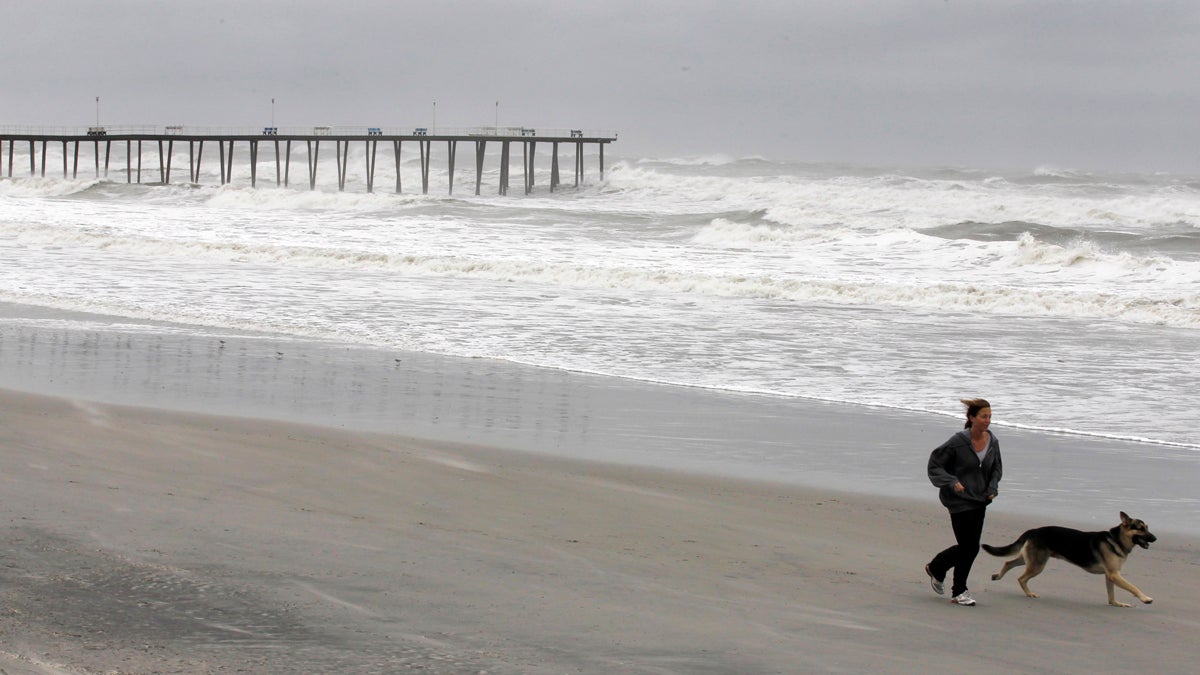 Lydia Liberto runs with her dog on the beach after Hurricane Irene, Sunday, Aug. 28, 2011, in Ventnor City, N.J. (Alex Brandon/AP Photo)
