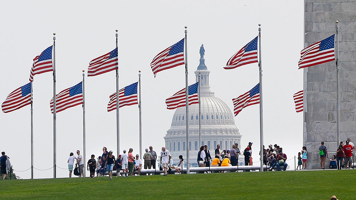  Visitors are seen at the base of the Washington Memorial, with the U.S. Capitol in the background, Wednesday, Aug. 2, 2017, in Washington. (Pablo Martinez Monsivais/AP Photo) 