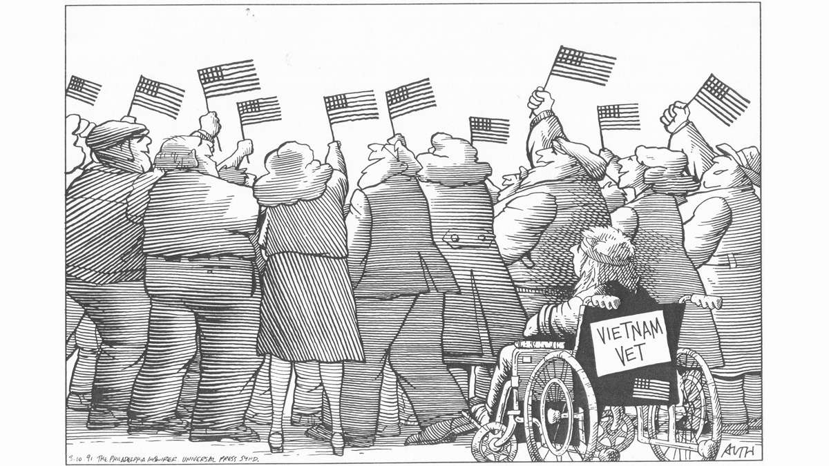 A Tony Auth cartoon, dated 1991, showing a row of people standing at a parade, waving small American flags, blocking the view of a Vietnam vet in a wheelchair.