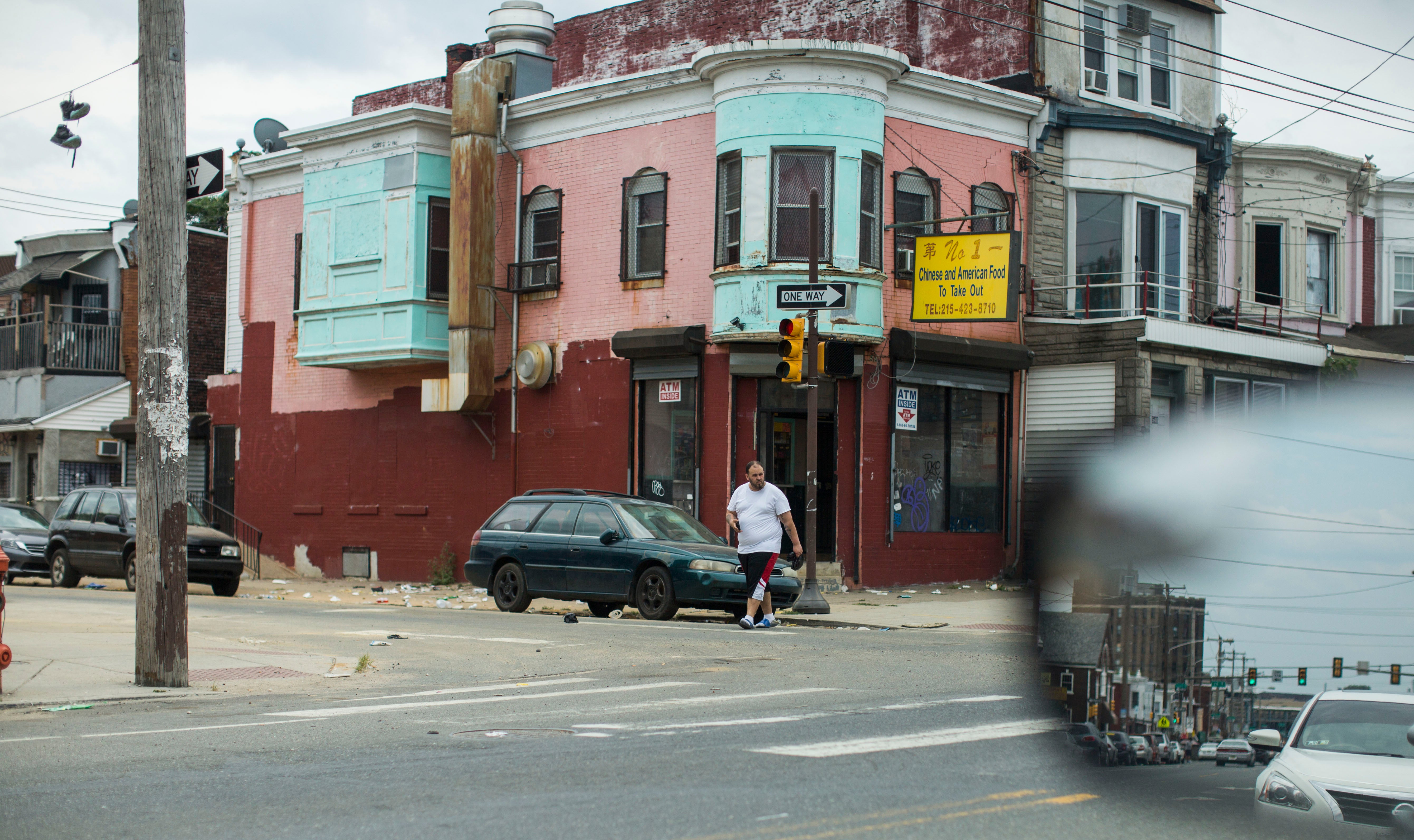 A trash-strewn corner in Kensington, Philadelphia. (Jessica Kourkounis/For Keystone Crossroads)