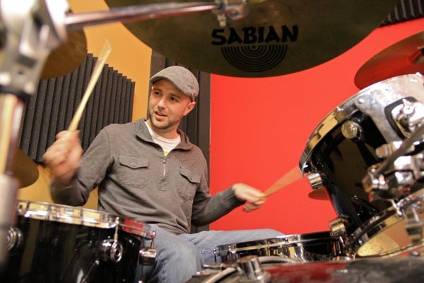 <p>Jerry Grantland plays the drums during a rehearsal at the School of Rock in Cherry Hill. (Emma Lee/for NewsWorks)</p>
