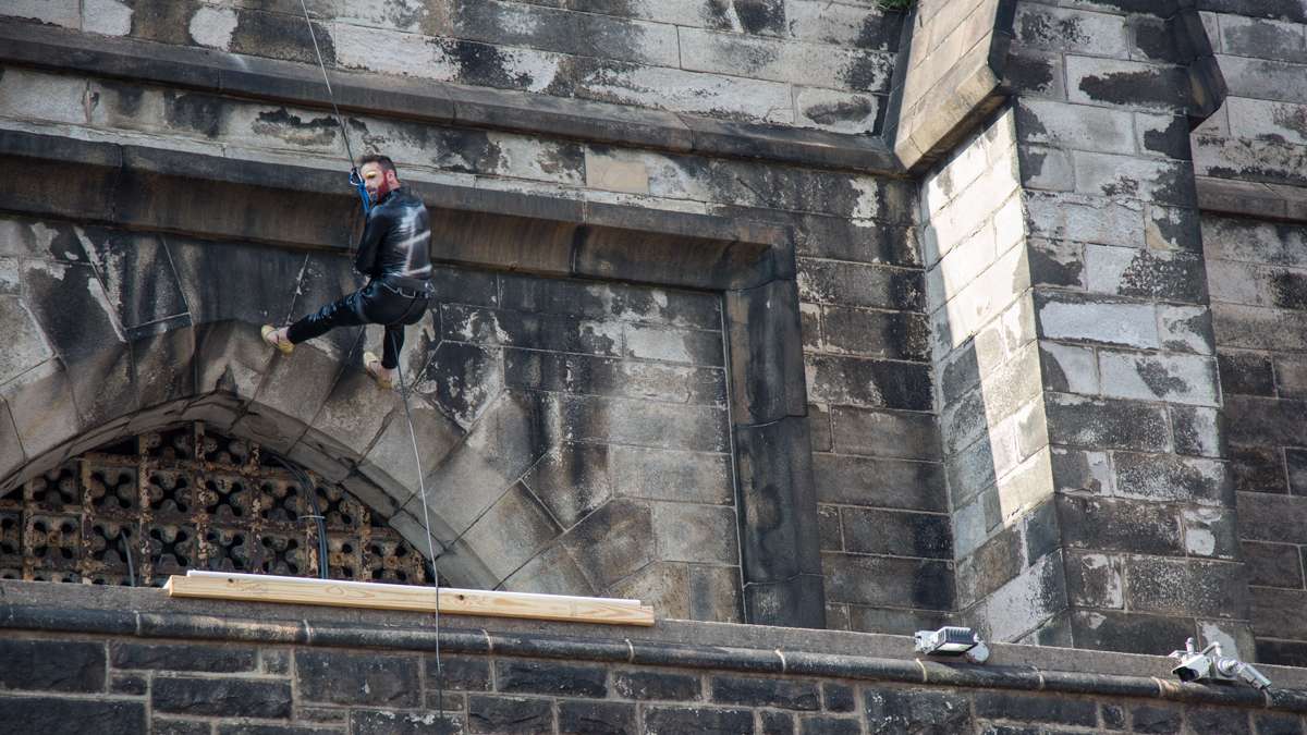 Edith Piaf, portrayed by John Jarboe, rappels down the Eastern State Penitentiary wall to save the show. The Bearded Ladies Cabaret performed their 23rd annual retelling of the storming of the Bastille, July 15, 2017. (Emily Cohen for NewsWorks)