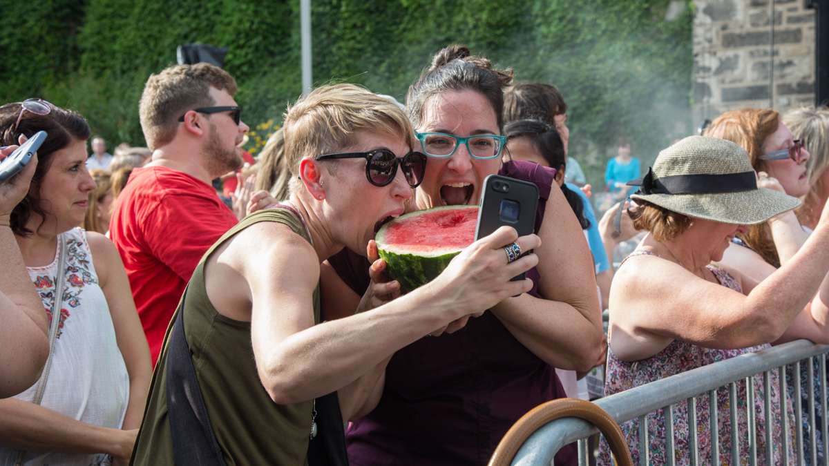Jaymi GIlmour (left) and Rachel Bondbaron, take a selfie as they dive into a guillotined watermelon