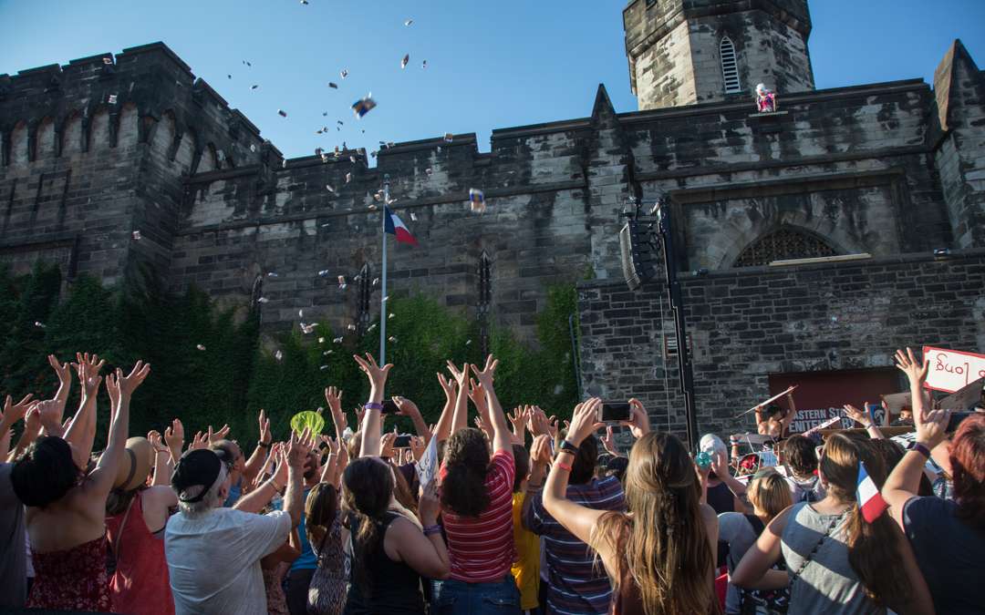 Tastykakes rain from the walls of Eastern State Penitentiary during the annual Bastille Day celebration at Eastern State Penitentiary