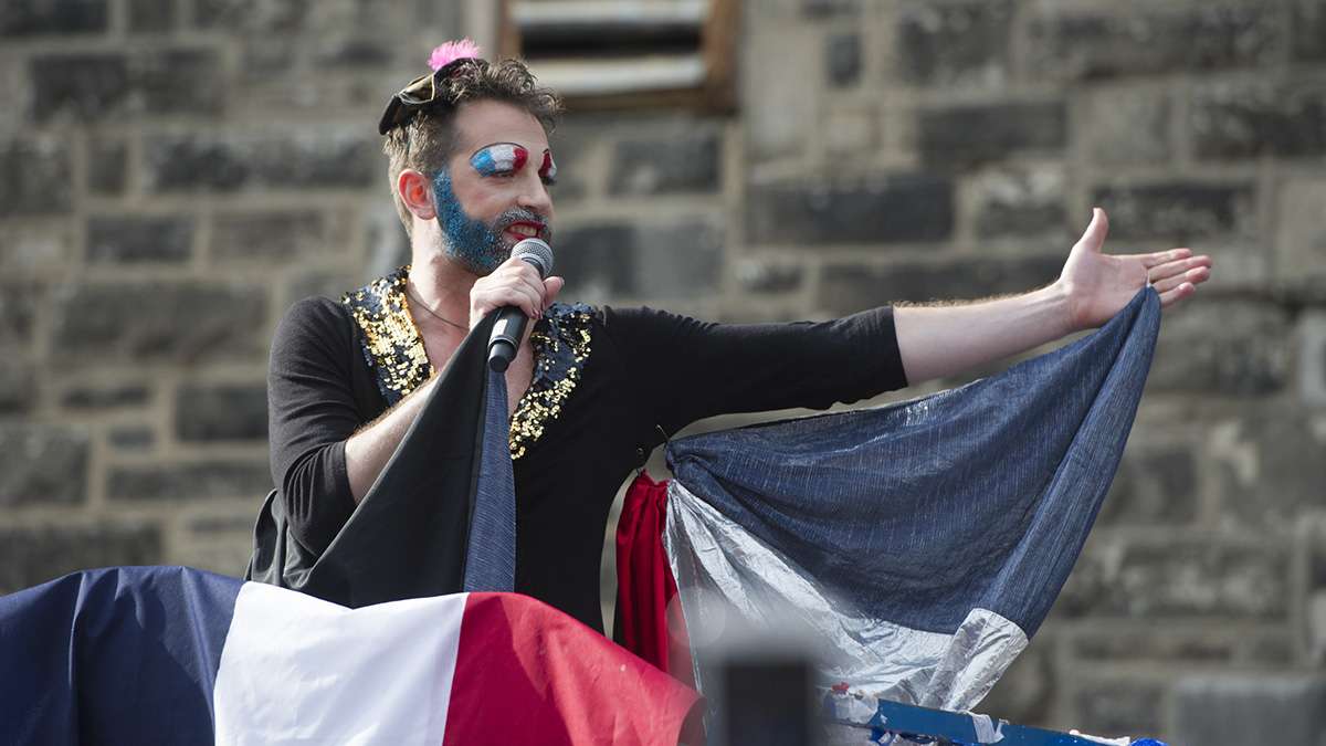 Bearded Ladies’ John Jarboe, playing Edith Piaf, greets the crowd at the beginning of the Bastille Day performance.