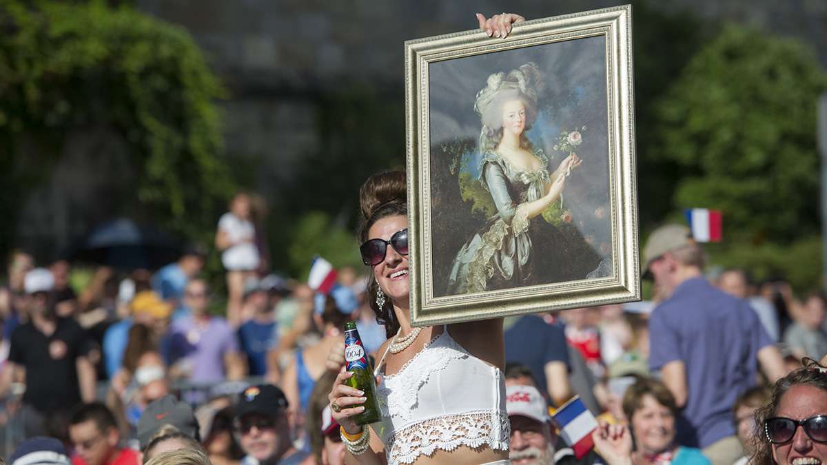 During the Bastille Day performance, Sandy Korenkiewicz holds up a portrait of Marie Antoinette